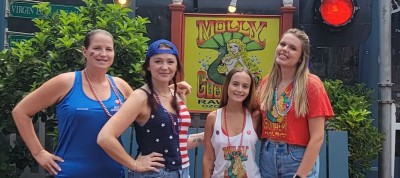 Friends outside Molly Goodhead's sign